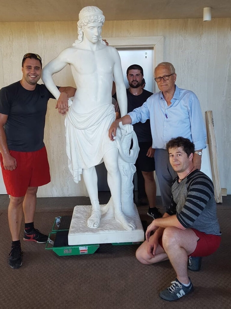 Crew handling a large heavy item with care